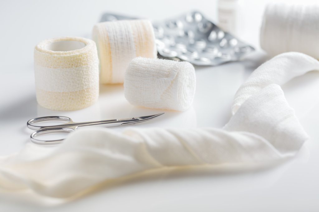 Home pharmacy, first aid kit concept with medical bandages, pills, thermometer and inhalator