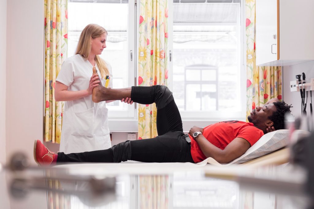 Young man with doctor during medical procedure